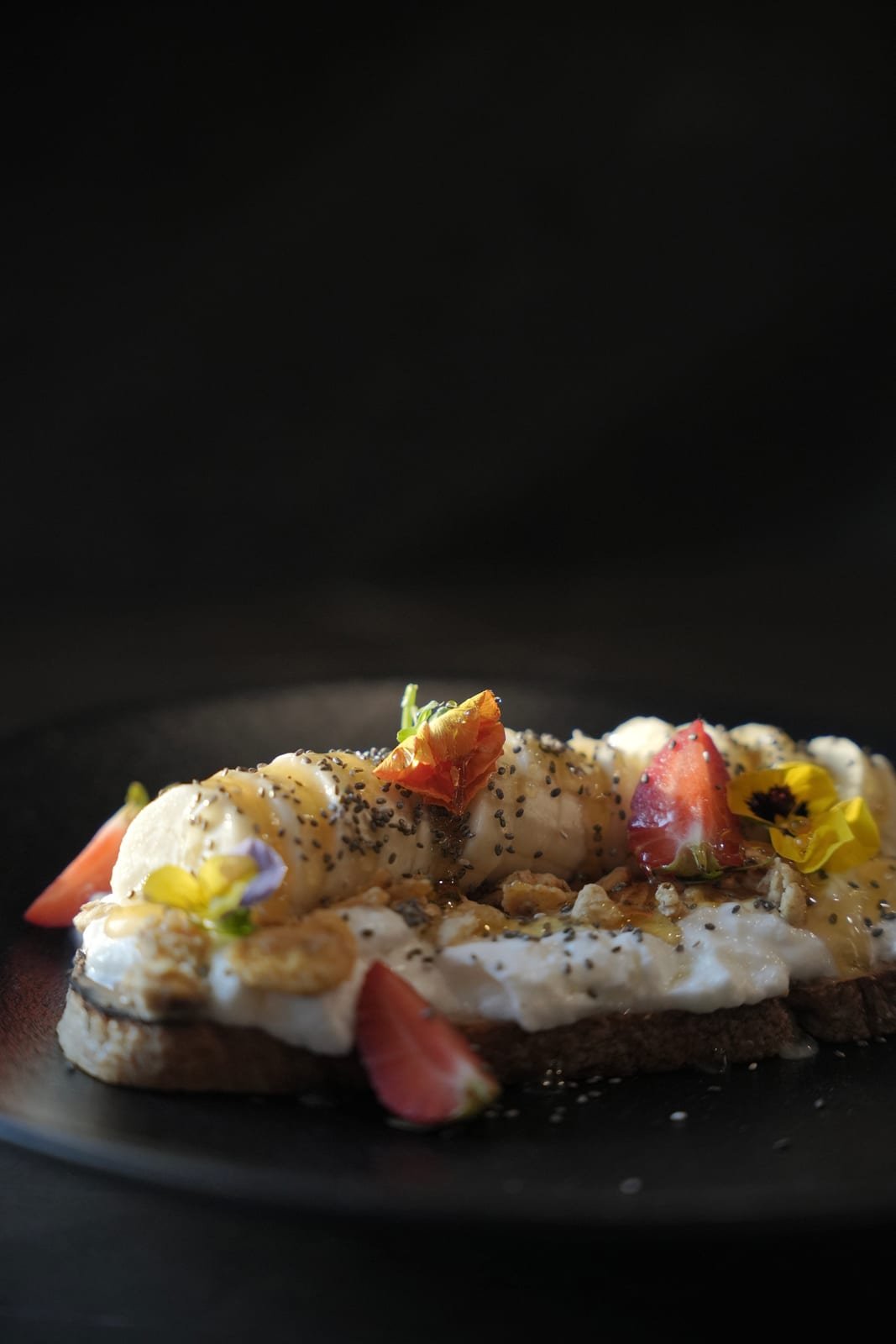 Sourdough toast with fruit and edible flowers